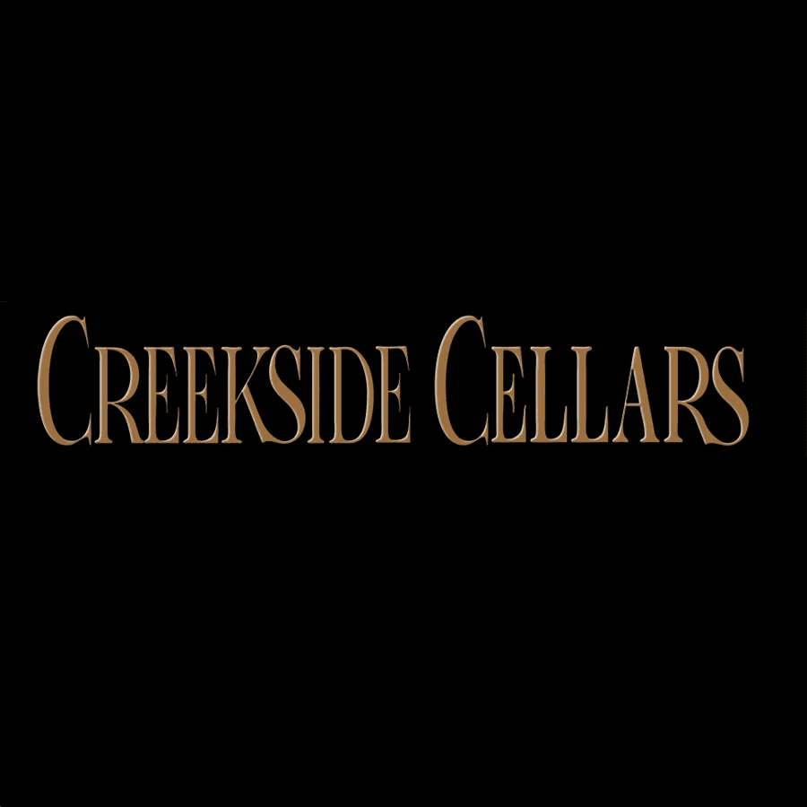 Text graphic featuring the words "Creekside Cellars" in gold on a black background.