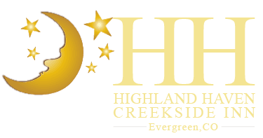 Logo for Highland Haven Creekside Inn featuring a crescent moon and stars, with the text "Highland Haven Creekside Inn, Evergreen, CO."